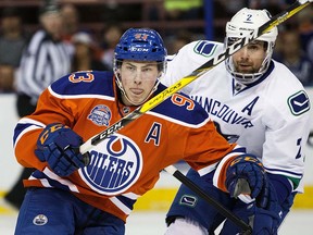 Ryan Nugent-Hopkins #93 of the Edmonton Oilers battles against Dan Hamhuis #2 of the Vancouver Canucks on April 6, 2016 at Rexall Place in Edmonton, Alberta, Canada. The game is the final game the Oilers will play at Rexall Place before moving to Rogers Place next season. (Photo by Codie McLachlan/Getty Images)