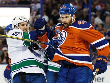 Zack Kassian #44 of the Edmonton Oilers shoves Alex Biega #55 of the Vancouver Canucks on April 6, 2016 at Rexall Place in Edmonton, Alberta, Canada. The game is the final game the Oilers will play at Rexall Place before moving to Rogers Place next season. (Photo by Codie McLachlan/Getty Images)