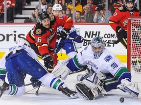 Ryan Miller makes a save against the Flames.