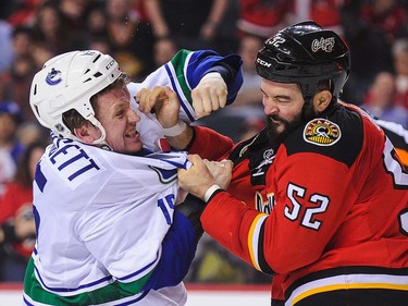 Brandon Bollig #52 of the Calgary Flames fights Derek Dorsett #15 of the Vancouver Canucks during an NHL game at Scotiabank Saddledome on April 7, 2016 in Calgary, Alberta, Canada. (Photo by Derek Leung/Getty Images)