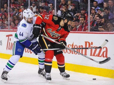 Brandon Bollig #52 of the Calgary Flames fights Matt Bartkowski #44 of the Vancouver Canucks during an NHL game at Scotiabank Saddledome on April 7, 2016 in Calgary, Alberta, Canada. (Photo by Derek Leung/Getty Images)