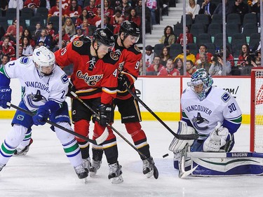 Sam Bennett #93 of the Calgary Flames takes a shot on Ryan Miller #30 of the Vancouver Canucks during an NHL game at Scotiabank Saddledome on April 7, 2016 in Calgary, Alberta, Canada. (Photo by Derek Leung/Getty Images)