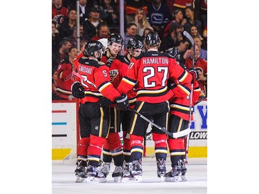 Joe Colborne #8 of the Calgary Flames celebrates with his teammates after scoring against the Vancouver Canucks during an NHL game at Scotiabank Saddledome on April 7, 2016 in Calgary, Alberta, Canada. (Photo by Derek Leung/Getty Images)