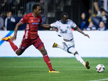 Vancouver Whitecaps' Kekuta Manneh, right, moves the ball past FC Dallas' Atiba Harris during the second half of an MLS soccer game in Vancouver, B.C., on  April 23, 2016.