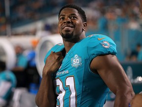 Cameron Wake of the Miami Dolphins looks on from the sidelines during a National Football League pre-season game last August. The former B.C. Lions star will be the keynote speaker Thursday at the Lions’ annual Orange Helmet Awards dinner.