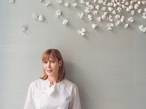 Australian chef Skye Gyngell against blossom decorations on the wall by Valeria Nascimento.