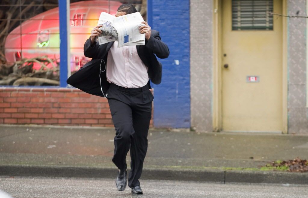 Former BC Lion Josh Boden runs across Main street, December 16th 2010, covering his face as he arrives to attend his sexual assault trial at Vancouver's Provincial court house. 