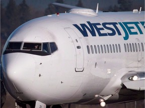 File: A pilot taxis a Westjet Boeing 737-700 plane to a gate after arriving at Vancouver International Airport in Richmond, B.C.