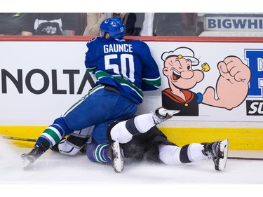 Vancouver Canucks' Brendan Gaunce (50) checks Los Angeles Kings' Jeff Carter during the second period of an NHL hockey game in Vancouver, B.C., on Monday April 4, 2016.