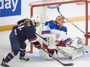 The U.S.'s Brianna Decker (14) is stopped by Russian goalie Anna Prugova during first-period semifinal action at the women's world hockey championships in Kamloops on Sunday. — The Canadian Press
