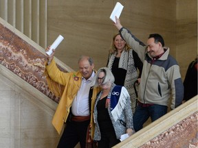 Bruce Dumont, president of the Metis Nation B.C. (left), Audrey Poitras, president of the Alberta Metis Nation (front), and Gerald Morin, vice-president of the Saskatchewan Metis Nation (right), celebrate after a decision at the Supreme Court of Canada in Ottawa on April 14.