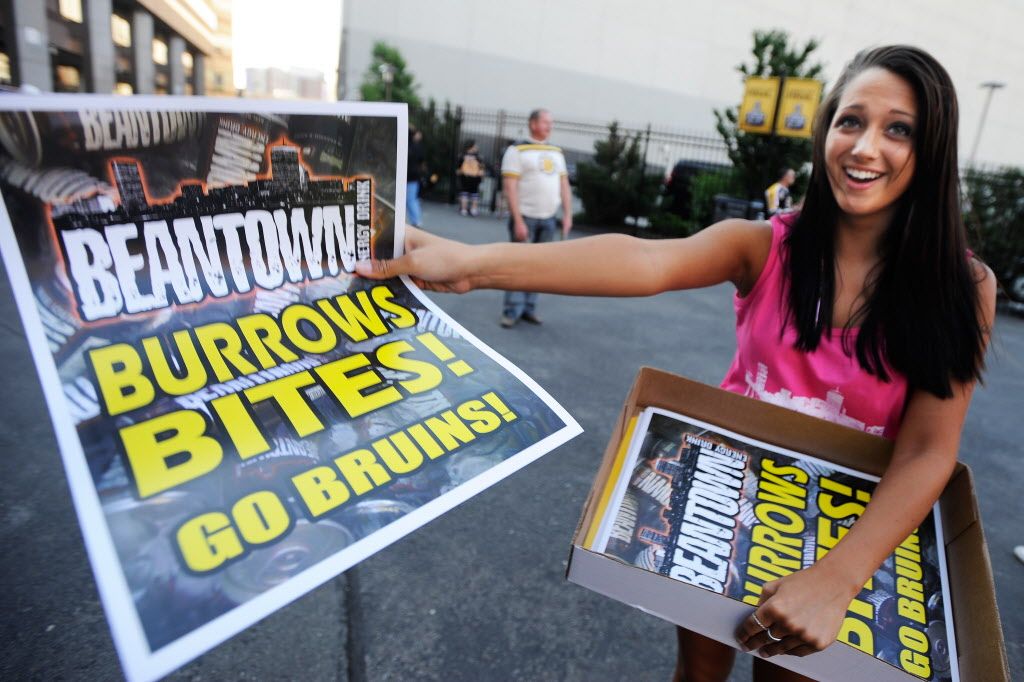 Sarah Dunphy hands out "Burrow Bites" posters to fans prior to game 3 of the NHL 2011 Stanley Cup final at TD Garden in Boston, MA June 6, 2011. 