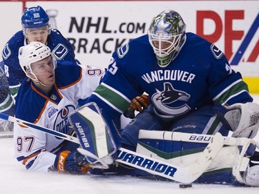 Vancouver Canucks #88 Nikita Tryamkin watches as Edmonton Oilers #97 Connor McDavid crashes into Canucksgoalie Jacob Markstrom during the second period of the final regular season NHL hockey game at Rogers Arena, Vancouver April 09 2016. ( Gerry Kahrmann  /  PNG staff photo)  ( For Prov / Sun Sports )  00042613A  [PNG Merlin Archive]