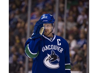 Vancouver Canucks #33 Henrik Sedin adjusts his visor during a break in play against the Edmonton Oilers  during the second period of the final regular season NHL hockey game at Rogers Arena, Vancouver April 09 2016. ( Gerry Kahrmann  /  PNG staff photo)  ( For Prov / Sun Sports )  00042613A  [PNG Merlin Archive]