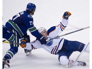 Vancouver Canucks #27 Ben Hutton is called for holding on Edmonton Oilers #97 Connor McDavid during this play in the third period of the final regular season NHL hockey game at Rogers Arena, Vancouver April 09 2016. ( Gerry Kahrmann  /  PNG staff photo)  ( For Prov / Sun Sports )  00042613A  [PNG Merlin Archive]