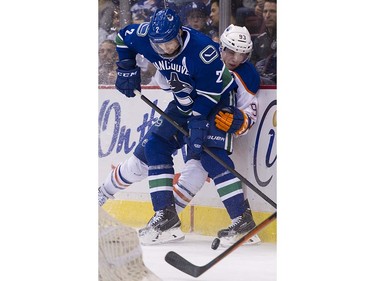 Vancouver Canucks #2 Dan Hamhuis keeps Edmonton Oilers #93 Ryan Nugent-Hopkins from the puck behind the net during the second period of the final regular season NHL hockey game at Rogers Arena, Vancouver April 09 2016. ( Gerry Kahrmann  /  PNG staff photo)  ( For Prov / Sun Sports )  00042613A  [PNG Merlin Archive]