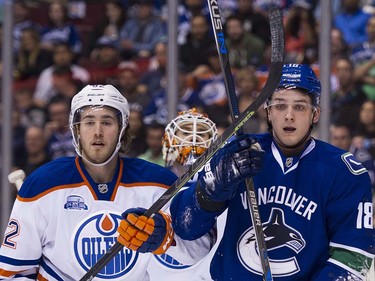 Edmonton Oiler goalie Cam Talbot trie to look between Vancouver Canucks #18 Jake Virtanen  Edmonton Oilers #82 Jordan Oesterle during the first period of the final regular season NHL hockey game at Rogers Arena, Vancouver April 09 2016. ( Gerry Kahrmann  /  PNG staff photo)  ( For Prov / Sun Sports )  00042613A  [PNG Merlin Archive]