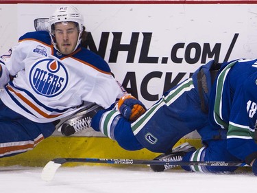 Vancouver Canucks #18 Jake Virtanen and Edmonton Oiler o82 end up on the ice during the first period of the final regular season NHL hockey game at Rogers Arena, Vancouver April 09 2016. ( Gerry Kahrmann  /  PNG staff photo)  ( For Prov / Sun Sports )  00042613A  [PNG Merlin Archive]