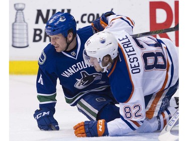 Vancouver Canucks #15 Derek Dorsett and Edmonton Oiler #82 Jordan Oesterle end up on the ice in front of the net during the first period of the final regular season NHL hockey game at Rogers Arena, Vancouver April 09 2016. ( Gerry Kahrmann  /  PNG staff photo)  ( For Prov / Sun Sports )  00042613A  [PNG Merlin Archive]