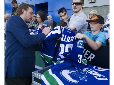 Canucks player  Matt Bartkowski signs autographs for fans as they meet the players at Pat Quinn Way outside Rogers Arena prior to the last game of the regular season, Vancouver April 09 2016. ( Gerry Kahrmann  /  PNG staff photo)  ( For Prov / Sun Sports )  00042648A  [PNG Merlin Archive]