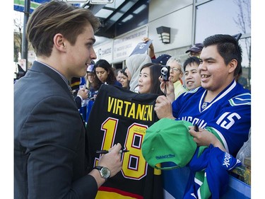 Canucks player Jake Virtanen signs autographs for fans as trey meet the players at Pat Quinn Way outside Rogers Arena prior to the last game of the regular season, Vancouver April 09 2016. ( Gerry Kahrmann  /  PNG staff photo)  ( For Prov / Sun Sports )  00042648A  [PNG Merlin Archive]