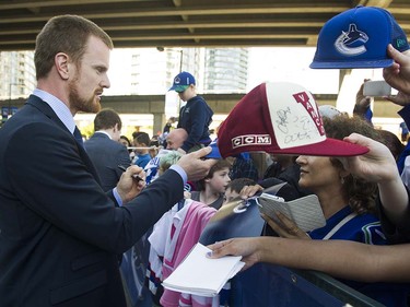 VANCOUVER  April 09 2016. Canucks player Daniel Sedin signs autographs for fans as they meet the players at Pat Quinn Way outside Rogers Arena prior to the last game of the regular season, Vancouver April 09 2016. ( Gerry Kahrmann  /  PNG staff photo)  ( For Prov / Sun Sports )  00042648A  [PNG Merlin Archive]