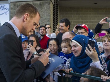 Canucks player Henrik Sedin signs autographs for fans as they meet the players at Pat Quinn Way outside Rogers Arena prior to the last game of the regular season, Vancouver April 09 2016. ( Gerry Kahrmann  /  PNG staff photo)  ( For Prov / Sun Sports )  00042648A  [PNG Merlin Archive]