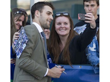 Canucks player Brandon Sutter has his photo taken with a fan at Pat Quinn Way outside Rogers Arena prior to the last game of the regular season, Vancouver April 09 2016. ( Gerry Kahrmann  /  PNG staff photo)  ( For Prov / Sun Sports )  00042648A  [PNG Merlin Archive]