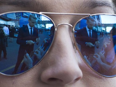 Canucks player Alex Edler is reflected in the glasses of fan Francesca Moore  as she meets the players at Pat Quinn Way outside Rogers Arena prior to the last game of the regular season, Vancouver April 09 2016. ( Gerry Kahrmann  /  PNG staff photo)  ( For Prov / Sun Sports )  00042648A  [PNG Merlin Archive]