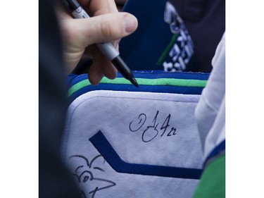 Canucks player Daniel Sedin signs autographs for fans as they meet the players at Pat Quinn Way outside Rogers Arena prior to the last game of the regular season, Vancouver April 09 2016. ( Gerry Kahrmann  /  PNG staff photo)  ( For Prov / Sun Sports )  00042648A  [PNG Merlin Archive]