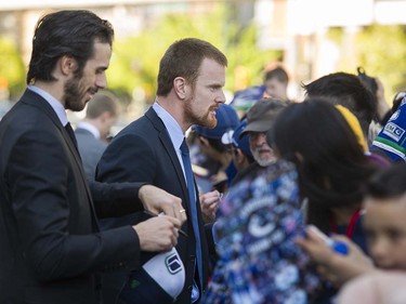 Canucks players  Ryan Miller ( L ) and Daniel Sedin ( R ) meet with players at Pat Quinn Way outside Rogers Arena prior to the last game of the regular season, Vancouver April 09 2016. ( Gerry Kahrmann  /  PNG staff photo)  ( For Prov / Sun Sports )  00042648A  [PNG Merlin Archive]