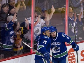 Vancouver Canucks #26 Emerson Etem and #15 Derek Dorsett celebrate Etem's goal on the Edmonton Oilers during the third period of the final regular season NHL hockey game at Rogers Arena, Vancouver April 09 2016.