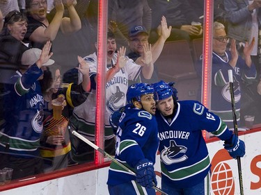 VANCOUVER  April 09 2016. Vancouver Canucks #26 Emerson Etem and #15 Derek Dorsett celebrate Etem's goal on the Edmonton Oilers during the third period of the final regular season NHL hockey game at Rogers Arena, Vancouver April 09 2016. ( Gerry Kahrmann  /  PNG staff photo)  ( For Prov / Sun Sports )  00042613A  [PNG Merlin Archive]