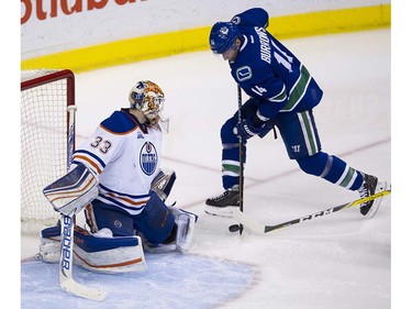 Vancouver Canucks #14 Alexandre Burrows riga for the puck in front of Edmonton Oilers goalie Cam Talbot during the third period of the final regular season NHL hockey game at Rogers Arena, Vancouver April 09 2016. ( Gerry Kahrmann  /  PNG staff photo)  ( For Prov / Sun Sports )  00042613A  [PNG Merlin Archive]