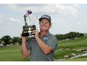 Charley Hoffman poses with his trophy after winning the Texas Open golf tournament, Sunday, April 24, 2016, in San Antonio.