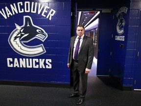 VANCOUVER, BC - NOVEMBER 23:  Vancouver Canucks goaltending coach Roland Melanson stands outside the team dressing room before their game against the Chicago Blackhawks at Rogers Arena November 23, 2014 in Vancouver, British Columbia, Canada.