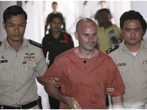 Thai prison guards escort Canadian Christopher Paul Neil, center, at criminal court in Bangkok, Thailand Friday, Aug. 15, 2008. A convicted pedophile who was once the subject of an international manhunt for allegedly posting his sexual assaults of children online after hiding his face behind a digital swirl has been arrested at Vancouver's airport.THE CANADIAN PRESS/AP,Sakchai Lalit [PNG Merlin Archive]