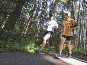 Yul Kwon, 80, and his daughter Janice, 46, train in Pacific Spirit Park near the University of British Columbia on Wednesday. He's running the BMO Vancouver Marathon on Sunday.