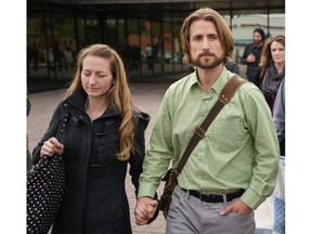 David and Collett Stephan leave the courthouse in Lethbridge, Alberta, April 26, 2016, surrounded by family and supporters after being found guilty in failing to provide the necessaries of life in the death of their 19-month-old son Ezekiel in 2012.