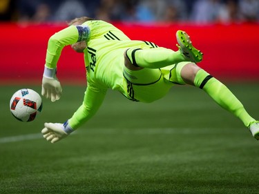 Vancouver Whitecaps goalkeeper David Ousted makes a diving save against FC Dallas during the first half of an MLS soccer game in Vancouver, B.C., on April 23, 2016.