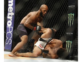 Demetrious Johnson, left, defeats Henry Cejudo during a flyweight championship mixed martial arts bout at UFC 197 Saturday in Las Vegas.