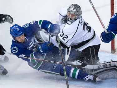 Vancouver Canucks' Derek Dorsett, left, crashes into Los Angeles Kings' goalie Jonathan Quick during the second period of an NHL hockey game in Vancouver, B.C., on Monday April 4, 2016.