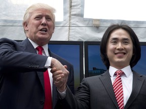 Joo Kim Tiah, CEO and president of Holborn Group, right, shakes hands with Donald Trump during an announcement in Vancouver in June 2013. The Trumps were on Canada's West Coast to announce the building of Trump International Hotel and Tower Vancouver.