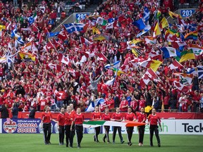 The Canadian and Mexican flags are carried onto the field before a FIFA World Cup qualifying soccer match in Vancouver, B.C., on Friday March 25, 2016.