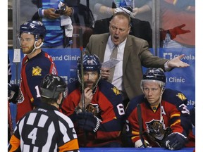 Florida Panthers head coach Gerard Gallant argues a call with referee Wes McCauley (4) during the third period of Game 2 in a first-round NHL hockey Stanley Cup playoff series against the New York Islanders, Friday, April 15, 2016, in Sunrise, Fla.