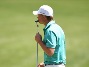 Jordan Spieth kisses his club after putting on the 16th hole during the first round of the 80th Masters Golf Tournament at the Augusta National Golf Club on Thursday in Augusta, Ga.