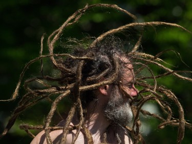 Haemish Muirhead's dreadlocks fly through the air as he dances during the annual 4/20 cannabis culture celebration at Sunset Beach in Vancouver, B.C., on Wednesday April 20, 2016.