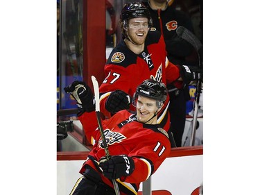 Calgary Flames' Mikael Backlund, right, from Sweden, is congratulated on his hat trick by teammate Dougie Hamilton during second period NHL hockey action against the Vancouver Canucks in Calgary, Thursday, April 7, 2016.THE CANADIAN PRESS/Jeff McIntosh