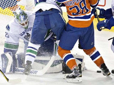 Vancouver Canucks goalie Jacob Markstrom (25) makes the save against the Edmonton Oilers during first period NHL action in Edmonton, Alta., on Wednesday April 6, 2016. THE CANADIAN PRESS/Jason Franson