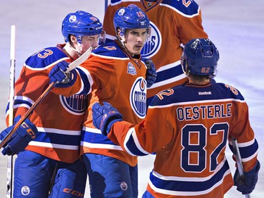 Edmonton Oilers' Ryan Nugent-Hopkins (93), Nail Yakupov (10) and Jordan Oesterle (82) celebrate a goal against the Vancouver Canucks during second period NHL action in Edmonton, Alta., on Wednesday April 6, 2016. THE CANADIAN PRESS/Jason Franson